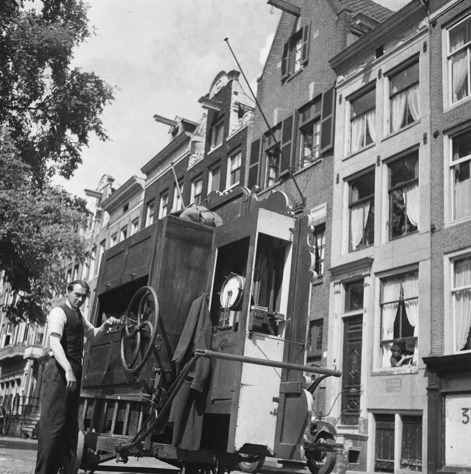Figure 2 — A Dutch draaiorgel (pierement) on an Amsterdam street: the bright mirror-and-scroll front with moving figures