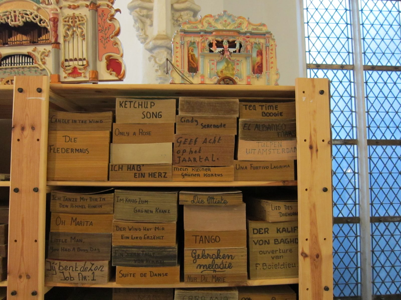 Figure 3 — A Gavioli-family grand key frame with its cardboard book, showing the breadth of a near-90-key scale