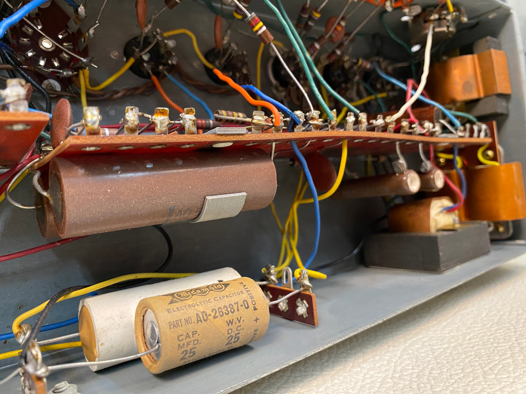 The underside of a B-3/C-3 AO-28 preamplifier chassis — point-to-point wiring, a Mallory electrolytic (Hammond part AO-26387-0) and the matching transformers that are the primary recap targets in a…