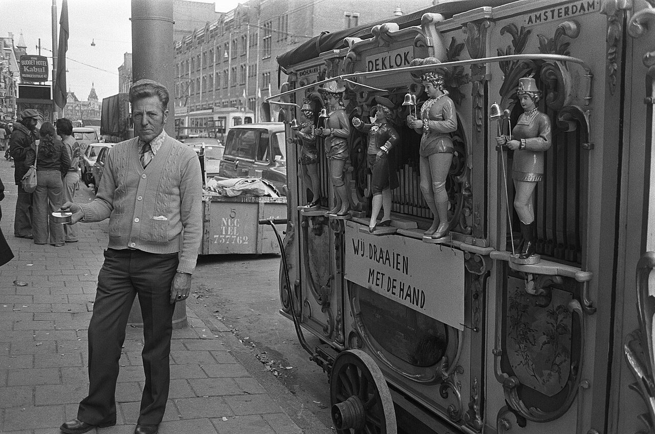 Figure 2 — A large Dutch street organ (draaiorgel / pierement) on its cart in Amsterdam, book-music driven, with an ornate carved façade — the big civic end of the street-organ family