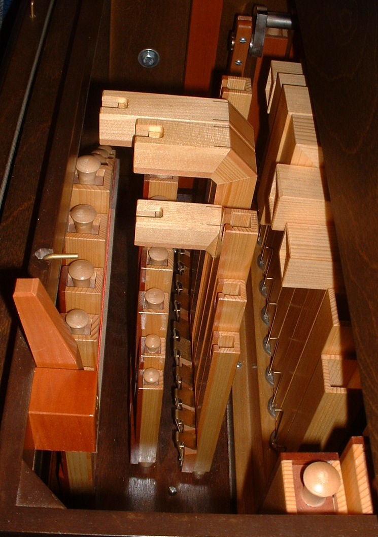 Figure 2 — A rank of stopped wooden Gedackt pipes with their movable wooden stoppers (handles visible at the top) — sliding the stopper tunes the pipe and is the coarse, forgiving tuning method unique to the …