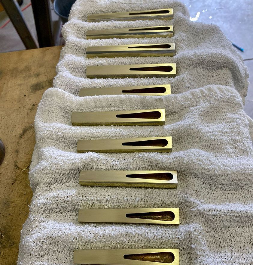 Figure 3 — A close-up set of shallots with their curved brass tongues, showing the flat bevelled facing the tongue beats against and the range of opening shapes that colour a reed's tone.