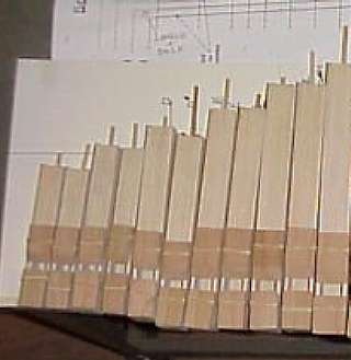Figure 2 — A batch of wooden flue pipes for a John Smith organ drying after glue-up, ranked by size before mounting.