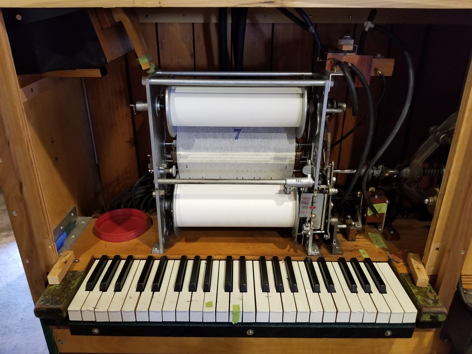 Figure 2 — An automatic (roll-operated) calliope: a paper roll over a tracker bar drives the note valves without a live player.