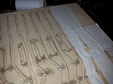 Figure 2 — A layered groundplate with jigsawn air channels papered over and being leak-tested before assembly