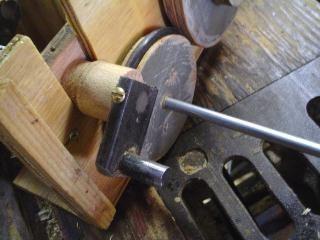 Figure 3 — The music-drive train: driving wheel, tyred idler wheel, and the take-up spool that pulls the paper roll, laid out along the crankshaft.