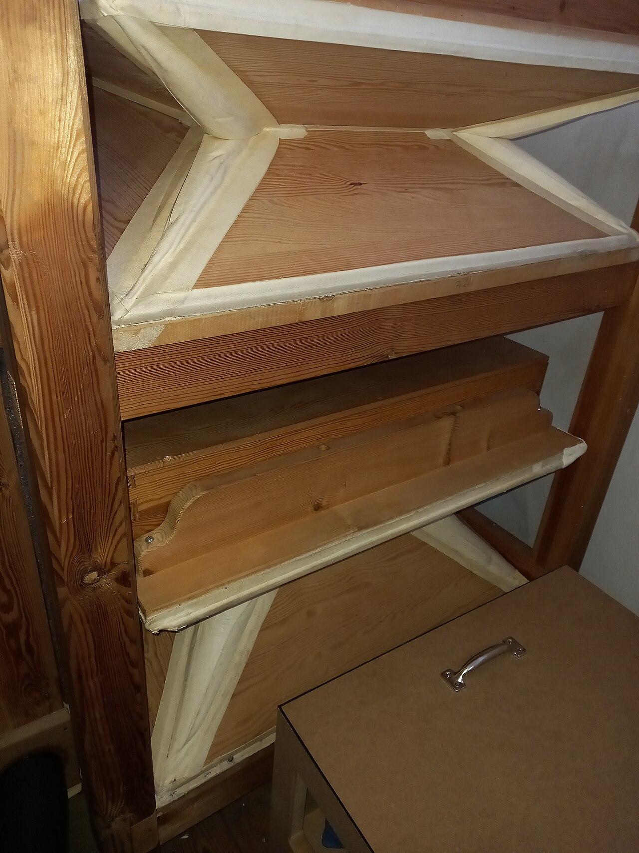 Figure 3 — A home-built busker-organ bellows and reservoir stack on the bench, feeders below and the sprung reservoir above, before covering.